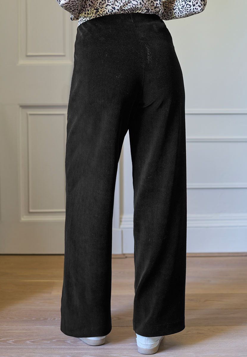 Fiona Wide Leg Cord Velour Trouser 27 Inch Leg - Black Endless Comfort Soft Drapey Stretch Cord Pull On Style Elasticated Waist and Zip Pockets Back View