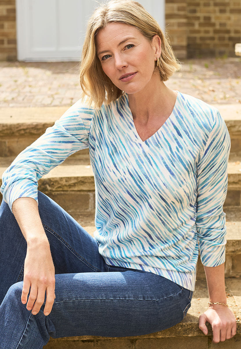 Sinead Printed V-Neck Jumper - Catlina Print Front Alt View Sat Down in Denim Jeans