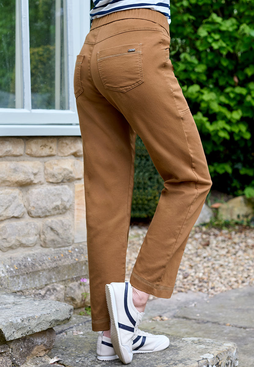 Toni Suki Tapered Trouser - Rich Caramel Soft Peach-Finish Fabric and Stretch For Extra Comfort Pull on Style With Deep Pockets Back View