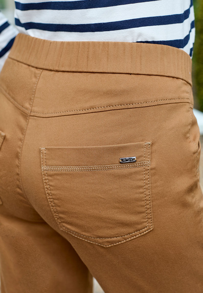 Toni Suki Tapered Trouser - Rich Caramel Soft Peach-Finish Fabric and Stretch For Extra Comfort Pull on Style With Deep Pockets Back Detail View